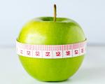 Apple with a tape measure around it