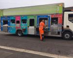 bin man wearing orange overalls stood next to a North Somerset recycling lorry