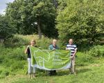 A photo of some of the friends of Trendlewood Community Park in Nailsea holding the Green Flag Award 2022/23.