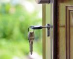 keys hanging in the lock of an open front door