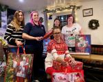 Volunteers at The Lamb Inn, Worle. Pictured from left to right: Keeley Vowels; Laura Hughes; Charley Hughes; Joanne Hughes (standing); and Mandi Dexter (seated) holding Christmas presents for people who are homeless or threatened with homelessness