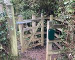 A photograph of a gate on a Public Rights of Way with a green box fixed to the post