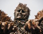 The Knife Angel shot from the ground, with its hands outstretched towards the camera. 