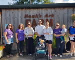 Group of volunteers, parents and babies outside Noah's Ark Zoo Farm.