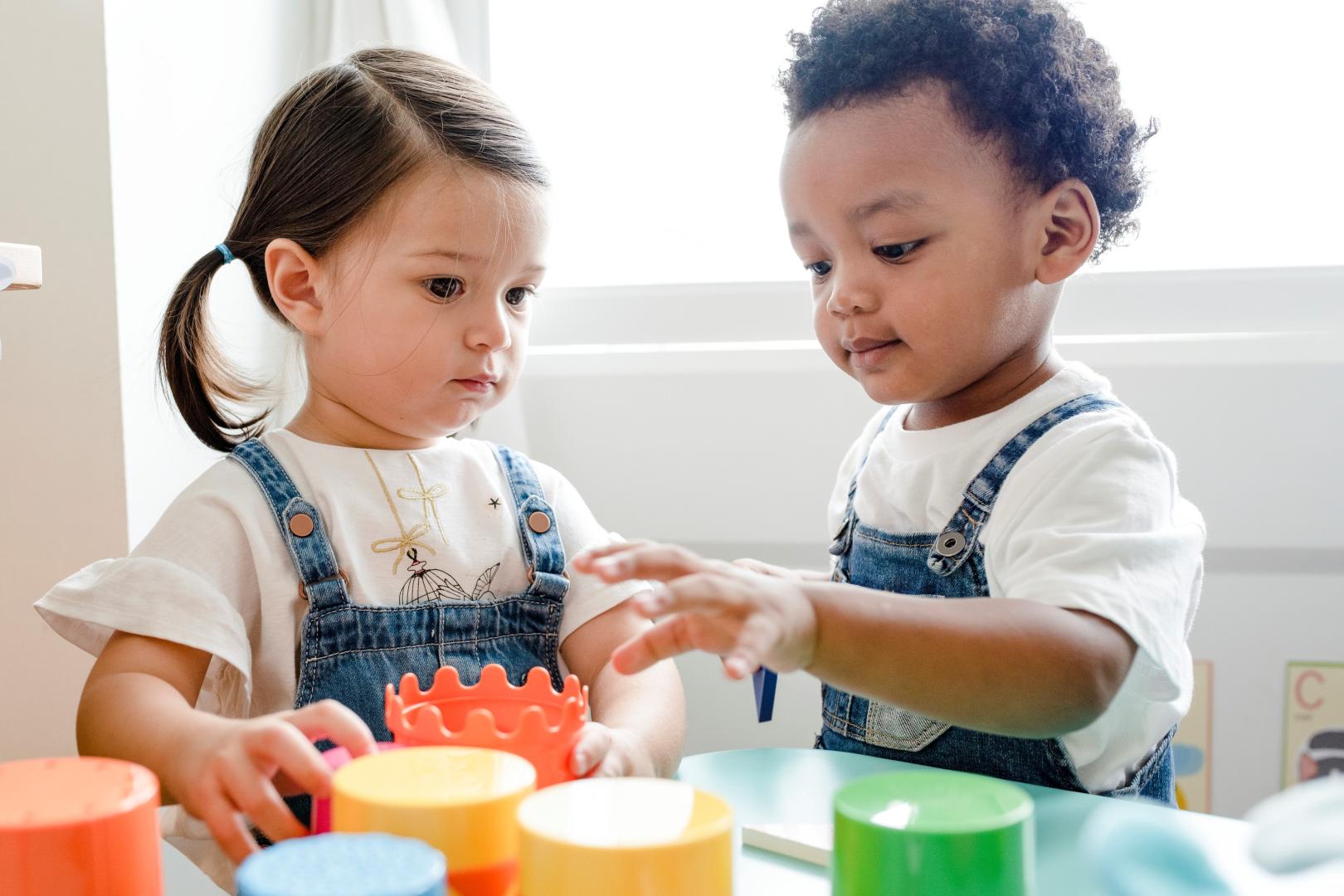 two children, toddler age, playing in a learning centre