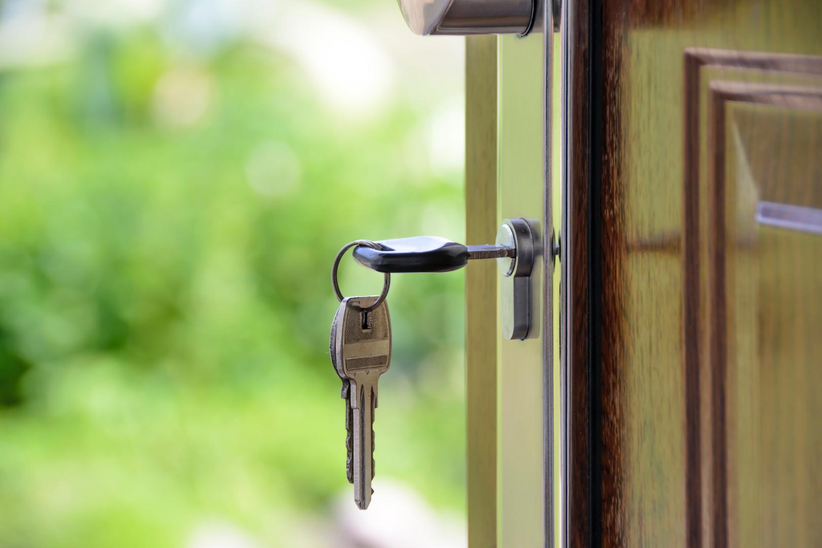 keys hanging in the lock of an open front door