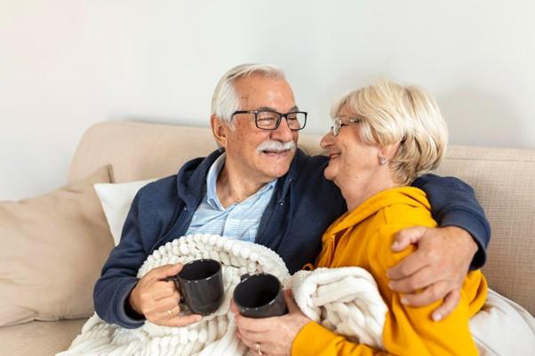 Couple drinking whilst keeping warm