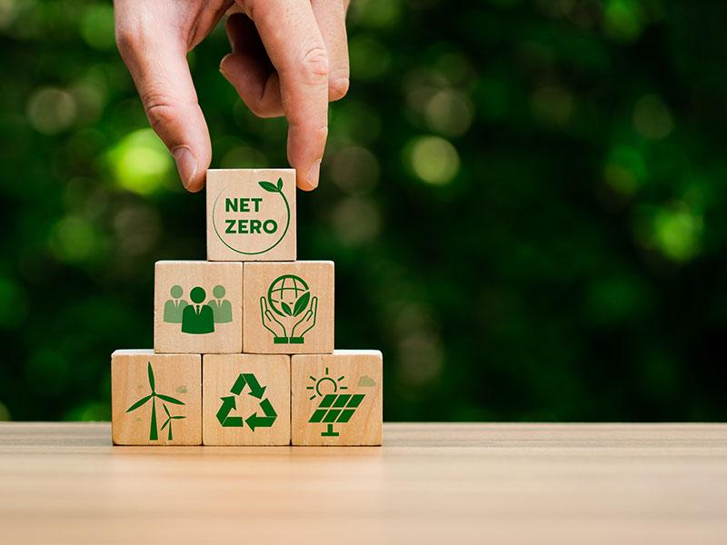 Pile of wooden cubes with net zero logos