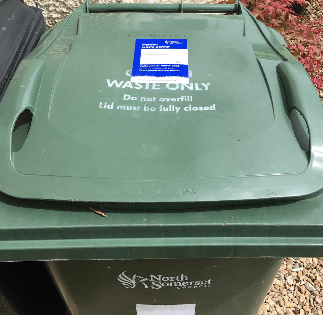 A North Somerset Council garden waste bin with a 2022-23 permit attached.