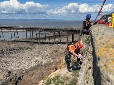 A group of workmen tend to the sea defences at Weston-super-Mare