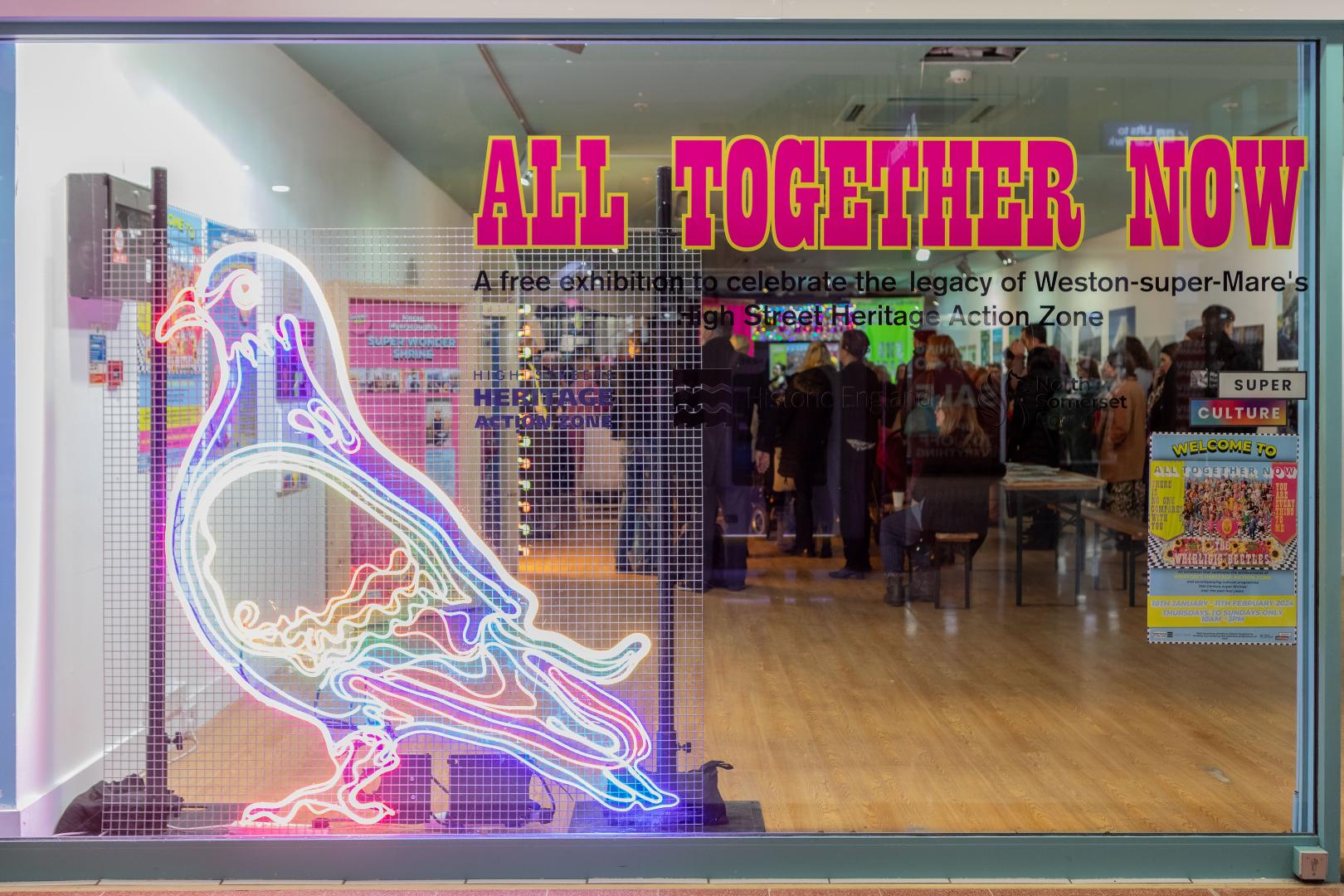 A photo to show the All Together Now exhibition display in the shopfront of unit 27 in the Sovereign