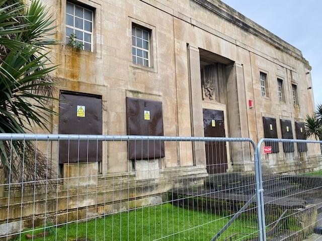 Former magistrates court with fencing outside