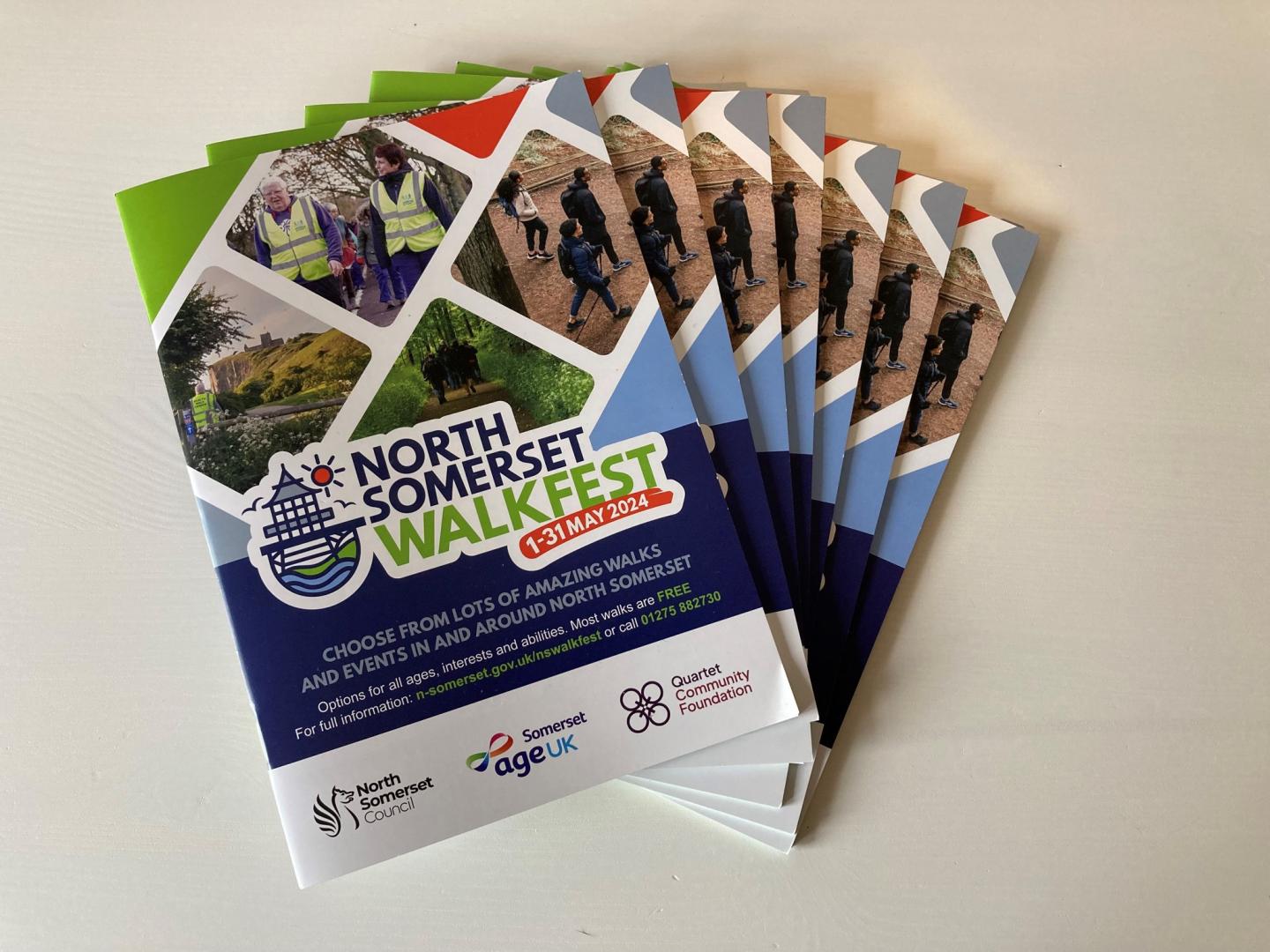 Seven Walk Fest programmes spread out on a table top