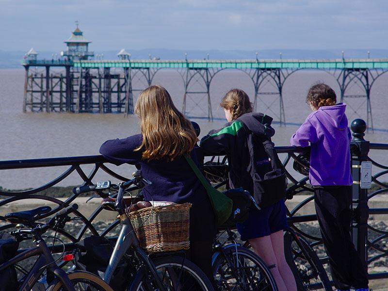 cyclists overlooking Clevedon PIer