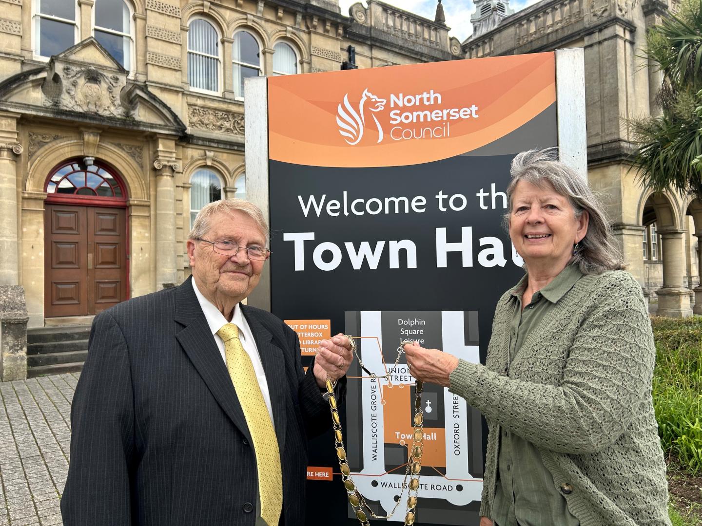 Cllr Wendy Griggs hands chains of office to Cllr Peter Crew