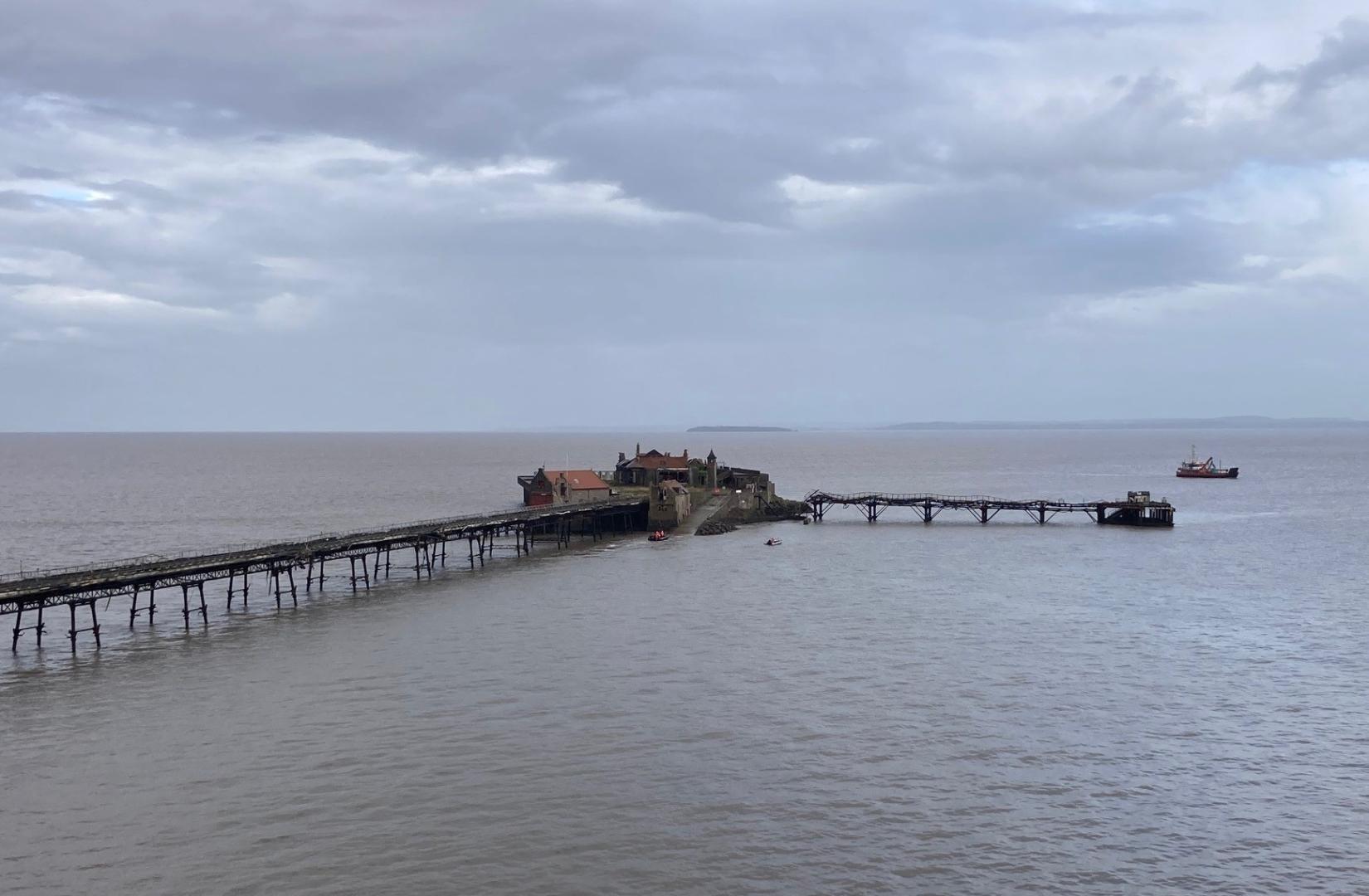 A photo of Birnbeck Island taken from the promenade at high tide with the first boats taking suppliers and workers 8 October 2024