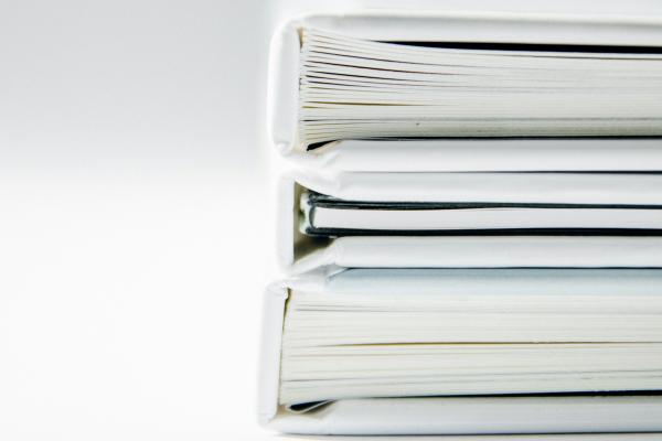 A white stack of books against a white background